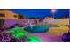 Private backyard pool with a rock waterfall feature and landscape lighting, creating a serene and luxurious outdoor living space at 528 Lavina Ct, Las Vegas, NV 89123