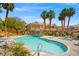 Beautiful community pool surrounded by palm trees and lounge chairs perfect for relaxing at 5855 Valley Dr # 2130, North Las Vegas, NV 89031