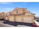 Exterior view of the condominium featuring a three-car garage, a tile roof, and a well maintained exterior at 5855 Valley Dr # 2130, North Las Vegas, NV 89031