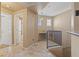 Upstairs hallway with tile floors, a built-in desk, and entrances to the bathrooms and bedrooms at 5855 Valley Dr # 2130, North Las Vegas, NV 89031
