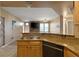View of kitchen featuring granite countertops and a breakfast bar connecting it with the living room at 5855 Valley Dr # 2130, North Las Vegas, NV 89031