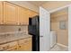 Functional kitchen with ample cabinetry and laundry closet featuring a washer and dryer at 5855 Valley Dr # 2130, North Las Vegas, NV 89031