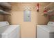 Practical laundry room with shelving and utility panel for storage and convenience at 5855 Valley Dr # 2130, North Las Vegas, NV 89031