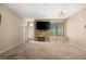 Spacious living room with a stone fireplace, large windows, and ample natural light at 5855 Valley Dr # 2130, North Las Vegas, NV 89031