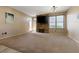 View of the carpeted living room featuring a fireplace and direct access to the outside at 5855 Valley Dr # 2130, North Las Vegas, NV 89031