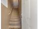View of the carpeted stairway leading to the second level of the home, with a white handrail at 5855 Valley Dr # 2130, North Las Vegas, NV 89031