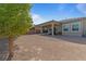 Spacious backyard with desert landscaping, covered patio, and lush, mature trees at 5953 Yellow Ridge Ave, Las Vegas, NV 89131