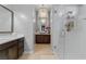 Bright bathroom featuring vanity, large mirror, crystal chandelier, and glass enclosed shower at 5953 Yellow Ridge Ave, Las Vegas, NV 89131