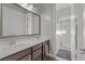 Bright bathroom with double vanity, large mirror, and glass-enclosed shower at 5953 Yellow Ridge Ave, Las Vegas, NV 89131