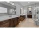 Elegant bathroom featuring dual vanities, a walk-in shower, and a chandelier at 5953 Yellow Ridge Ave, Las Vegas, NV 89131