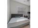 Bedroom with platform bed, side table, and a modern window shade at 5953 Yellow Ridge Ave, Las Vegas, NV 89131