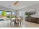 Bright dining area features stylish light fixture, modern decor, and sliding glass doors at 5953 Yellow Ridge Ave, Las Vegas, NV 89131