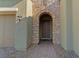 Inviting stone-framed front door with brick pathway and lush landscaping at 5953 Yellow Ridge Ave, Las Vegas, NV 89131