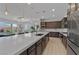 Modern kitchen featuring a large island with a sink, stainless steel appliances, and dark wood cabinetry at 5953 Yellow Ridge Ave, Las Vegas, NV 89131