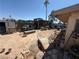 Overgrown backyard featuring partial wooden and block fencing, outbuildings and personal property scattered throughout at 6271 Explorer Dr, Las Vegas, NV 89103
