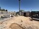 Overgrown backyard featuring partial block wall, outbuildings and an abundance of personal property scattered throughout at 6271 Explorer Dr, Las Vegas, NV 89103