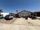 Single story home with a two-car garage and a cluttered driveway with a truck at 6271 Explorer Dr, Las Vegas, NV 89103