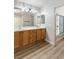 Bathroom showcasing double sinks, wooden cabinets, and a shower with sliding doors at 6525 Raven Hall St, North Las Vegas, NV 89084
