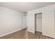 Minimalist bedroom with closet, neutral walls, and wood-look flooring at 6525 Raven Hall St, North Las Vegas, NV 89084