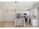 Well-lit kitchen with stainless appliances, granite counters, breakfast bar, and open-concept layout at 6525 Raven Hall St, North Las Vegas, NV 89084