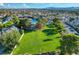 Expansive green lawn perfect for outdoor activities, surrounded by lush greenery and the community pool at 6652 Coral Springs Cir, Las Vegas, NV 89108