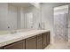 Bathroom with a double sink vanity and a view into the toilet and shower area at 6652 Coral Springs Cir, Las Vegas, NV 89108