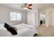 Bright bedroom with carpet, ceiling fan, sliding closet doors, and access to an en-suite bathroom at 6652 Coral Springs Cir, Las Vegas, NV 89108