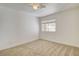 A bright bedroom featuring neutral carpet, a ceiling fan, and a window providing natural light at 6652 Coral Springs Cir, Las Vegas, NV 89108