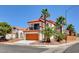 Two-story home featuring a charming front balcony, desert landscaping, and an orange garage door at 6652 Coral Springs Cir, Las Vegas, NV 89108