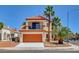 Two-story home with an orange tile roof, balcony, and desert landscaping at 6652 Coral Springs Cir, Las Vegas, NV 89108