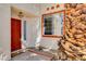 Inviting front entrance with a red door, trimmed window, and a charming 'hello' doormat at 6652 Coral Springs Cir, Las Vegas, NV 89108