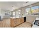 Open-concept kitchen featuring an island with sink, wooden cabinets, and stainless steel appliances at 6652 Coral Springs Cir, Las Vegas, NV 89108