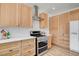 Modern kitchen with stainless steel appliances, light wood cabinets, and white subway tile backsplash at 6652 Coral Springs Cir, Las Vegas, NV 89108