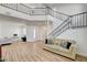Open living area featuring modern flooring, a staircase, and ample space for comfortable seating at 6652 Coral Springs Cir, Las Vegas, NV 89108