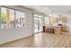 Open-concept living space with a kitchen island, access to the backyard, and hardwood floors at 6652 Coral Springs Cir, Las Vegas, NV 89108