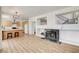 Open-concept living space with kitchen views, a modern fireplace, and a staircase to the upper level at 6652 Coral Springs Cir, Las Vegas, NV 89108