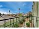 Balcony view with street view of palm trees and houses in a quiet neighborhood at 7066 Burcot Ave # 59, Las Vegas, NV 89156