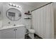 Bright bathroom featuring white vanity, decorative shelves, updated fixtures and a shower at 7066 Burcot Ave # 59, Las Vegas, NV 89156