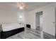 Cozy bedroom features a ceiling fan, light gray wood floors, and access to the hallway at 7066 Burcot Ave # 59, Las Vegas, NV 89156
