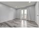 Bright bedroom with wood-look floors and French doors to balcony filling the room with natural light at 7066 Burcot Ave # 59, Las Vegas, NV 89156
