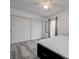 Bedroom with closet and balcony entrance featuring gray wood floors and ceiling fan at 7066 Burcot Ave # 59, Las Vegas, NV 89156