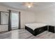 Bright bedroom features a ceiling fan, wood floors, and a sliding glass door to a balcony at 7066 Burcot Ave # 59, Las Vegas, NV 89156