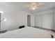 Bedroom features a ceiling fan, light gray wood floors, closet, and access to the hallway at 7066 Burcot Ave # 59, Las Vegas, NV 89156