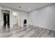 Bedroom featuring light gray walls, wood-look floors, and bathroom with an elegant vanity at 7066 Burcot Ave # 59, Las Vegas, NV 89156