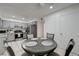 The kitchen and dining area offers modern appliances, gray cabinets, and a breakfast table at 7066 Burcot Ave # 59, Las Vegas, NV 89156