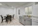 The kitchen and dining area offers stainless appliances, gray cabinets, and bright light at 7066 Burcot Ave # 59, Las Vegas, NV 89156