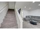 Inviting living room with staircase, plush gray sectional, and modern coffee table at 7066 Burcot Ave # 59, Las Vegas, NV 89156