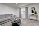 Relaxing living room showcasing a plush gray sofa, stylish side table, and natural light at 7066 Burcot Ave # 59, Las Vegas, NV 89156