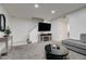 Bright living room featuring stylish decor, television and stairs leading to upper level at 7066 Burcot Ave # 59, Las Vegas, NV 89156