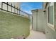 Exterior patio with textured concrete walls and a metal gate at 7066 Burcot Ave # 59, Las Vegas, NV 89156